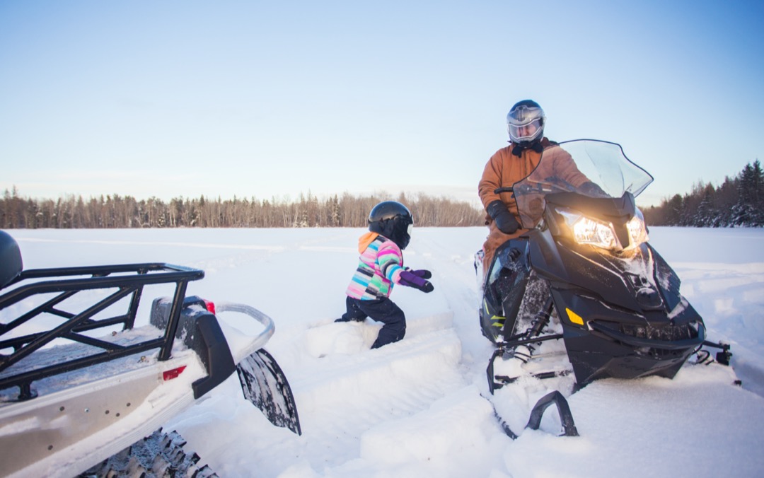 Family going snowmobiling in Whitecourt